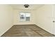 Spacious bedroom with wood-look floors and a large window at 5467 Vineland Rd # 6308, Orlando, FL 32811
