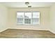 Bright bedroom with large window and wood floors at 5467 Vineland Rd # 6308, Orlando, FL 32811