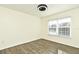 Spacious bedroom with wood-look floors and large window at 5467 Vineland Rd # 6308, Orlando, FL 32811