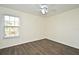 Bright bedroom with wood-look floors and window blinds at 5467 Vineland Rd # 6308, Orlando, FL 32811