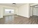 Sunlit dining room with wood-look floors and a large window at 5467 Vineland Rd # 6308, Orlando, FL 32811