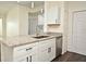 Modern kitchen with white cabinets, granite counters, and stainless steel appliances at 5467 Vineland Rd # 6308, Orlando, FL 32811
