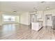 Open living room with kitchen and large window at 5467 Vineland Rd # 6308, Orlando, FL 32811