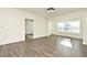 Bright and airy living room with wood-look floors and a sunlit space at 5467 Vineland Rd # 6308, Orlando, FL 32811