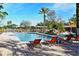 Community pool with lounge chairs and a pergola at 5467 Vineland Rd # 6308, Orlando, FL 32811