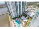 High-angle view of resort-style pool and surrounding green space at 241 Riverside Dr # 1901, Daytona Beach, FL 32117