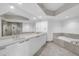 Large bathroom with double vanity and soaking tub at 241 Riverside Dr # 1901, Daytona Beach, FL 32117