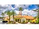 Community clubhouse with attractive landscaping and palm trees at 5467 Vineland Rd # 6308, Orlando, FL 32811