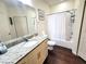 Clean bathroom with granite vanity, tub shower, and updated flooring at 8959 Shine Dr, Kissimmee, FL 34747