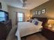Spacious Primary bedroom with a king-size bed and large TV at 8959 Shine Dr, Kissimmee, FL 34747