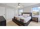 Main bedroom with a king-size bed, large windows, and abundant natural light at 126 Pompano Beach Dr, Kissimmee, FL 34746