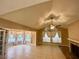 Living room with vaulted ceiling, tile floors, and fireplace at 936 Birmingham Ct # 200, Lake Mary, FL 32746