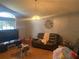 Bright living room with hardwood floors, large TV, and ample seating at 4336 Cypress Bay Ct, Orlando, FL 32822