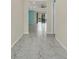 View down a bright hallway with tile floors at 687 Irvine Ranch Rd, Kissimmee, FL 34759