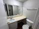 Small bathroom with toilet, sink, and mirror at 4267 S Semoran Blvd # 19, Orlando, FL 32822