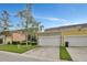 Townhouse exterior with two-car garage and well-maintained landscaping at 1383 Alston Bay Blvd, Apopka, FL 32703