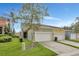 Townhouse exterior with two-car garage and well-maintained landscaping at 1383 Alston Bay Blvd, Apopka, FL 32703