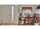 Formal dining room featuring a wood table and chairs, hardwood floors, and a view of the front door at 1383 Alston Bay Blvd, Apopka, FL 32703