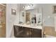 Double vanity bathroom with dark brown cabinets and a large mirror at 1383 Alston Bay Blvd, Apopka, FL 32703