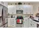 Modern kitchen with white cabinets, stainless steel appliances, and ample counter space at 1383 Alston Bay Blvd, Apopka, FL 32703