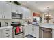 Modern kitchen with white cabinets, stainless steel appliances, and ample counter space at 1383 Alston Bay Blvd, Apopka, FL 32703