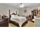 Main bedroom with a large bed, dark wood furniture, and a ceiling fan at 1383 Alston Bay Blvd, Apopka, FL 32703