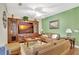 Spacious living room with brown leather sofas, wood entertainment center, and a large TV at 1383 Alston Bay Blvd, Apopka, FL 32703