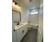 Clean bathroom with white vanity, bathtub, and marble shower at 2827 Sw 146Th Place Rd, Ocala, FL 34473