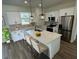Modern kitchen with white cabinets, quartz countertops, and stainless steel appliances at 2827 Sw 146Th Place Rd, Ocala, FL 34473