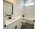 Stylish bathroom features a white vanity and a marble shower at 2827 Sw 146Th Place Rd, Ocala, FL 34473