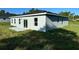 Side view of single-story home with gray exterior, sliding glass doors, and patio at 13053 Sw 36Th Ct, Ocala, FL 34473