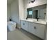 Large bathroom with double sinks, modern cabinets, and a free-standing tub at 13053 Sw 36Th Ct, Ocala, FL 34473