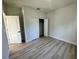 Simple bedroom with wood-look floors and a closet at 13053 Sw 36Th Ct, Ocala, FL 34473