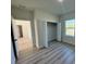 Bright bedroom with wood-look floors and a spacious closet at 13053 Sw 36Th Ct, Ocala, FL 34473
