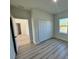 Bright bedroom with wood-look floors and a spacious closet at 13053 Sw 36Th Ct, Ocala, FL 34473