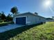 Side view of a single-story home with gray exterior and two-car garage at 13053 Sw 36Th Ct, Ocala, FL 34473
