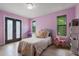 Bright bedroom with light wood floors and plenty of light at 1451 Lyndale Blvd, Winter Park, FL 32789