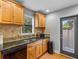 Cozy kitchen with wood cabinets, granite countertops, and modern appliances at 1451 Lyndale Blvd, Winter Park, FL 32789