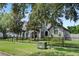 Two story house with gray siding, black fence, and lush landscaping at 1451 Lyndale Blvd, Winter Park, FL 32789