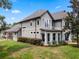 Gray two-story house with balcony, attached garage, and neatly trimmed hedges at 1451 Lyndale Blvd, Winter Park, FL 32789