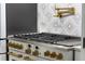 Modern kitchen with stainless steel appliances and gold accents at 1451 Lyndale Blvd, Winter Park, FL 32789