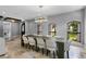 Elegant dining room with a large table, white chairs, and a modern chandelier at 1451 Lyndale Blvd, Winter Park, FL 32789