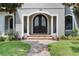 Elegant arched double front doors, brick pathway, and landscaping at 1451 Lyndale Blvd, Winter Park, FL 32789