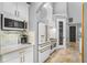 Modern kitchen with white cabinets and gold hardware at 1451 Lyndale Blvd, Winter Park, FL 32789