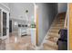 Modern kitchen with island and stainless steel appliances, adjacent to a staircase at 1451 Lyndale Blvd, Winter Park, FL 32789