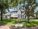 Two-story house with gray siding, black fence, and manicured lawn at 1451 Lyndale Blvd, Winter Park, FL 32789