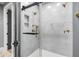 Elegant bathroom with a walk-in shower, marble tile, and gold accents at 1451 Lyndale Blvd, Winter Park, FL 32789