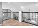 Upstairs hallway with hardwood floors and modern metal railing at 1451 Lyndale Blvd, Winter Park, FL 32789