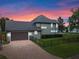Home's side view, showcasing garage and landscaping at 1451 Lyndale Blvd, Winter Park, FL 32789