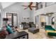 Spacious living room with leather couches, high ceilings and stone feature wall at 1451 Lyndale Blvd, Winter Park, FL 32789